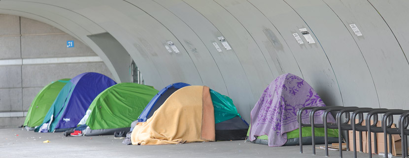 six tents on street showing homelessness encampment
