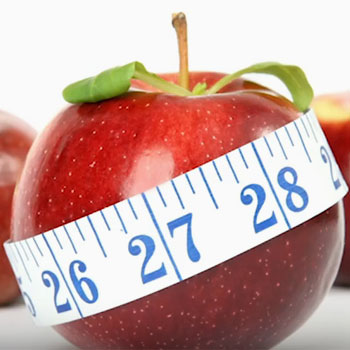 apple wrapped in measuring tape