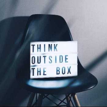 chair with sign saying think outside the box