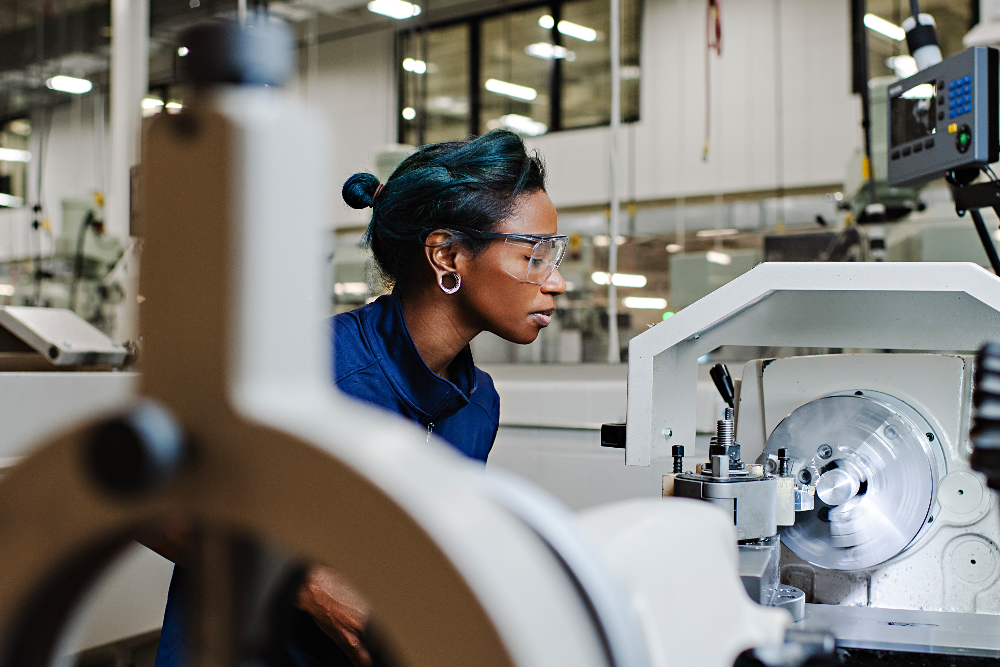 a woman works on a machine