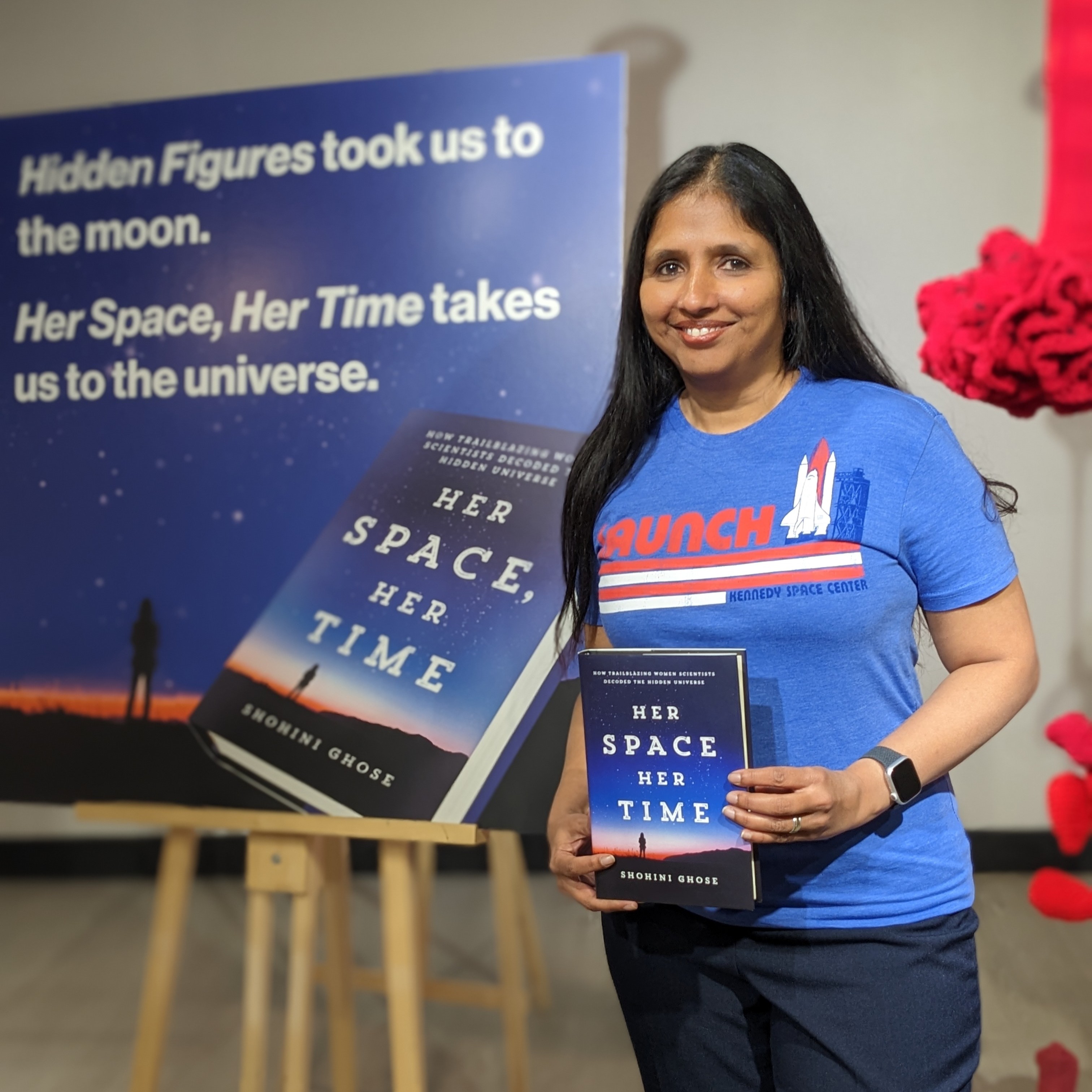 a woman poses with a book