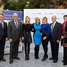 group posing in front of Laurier and Sun Life Financial banners