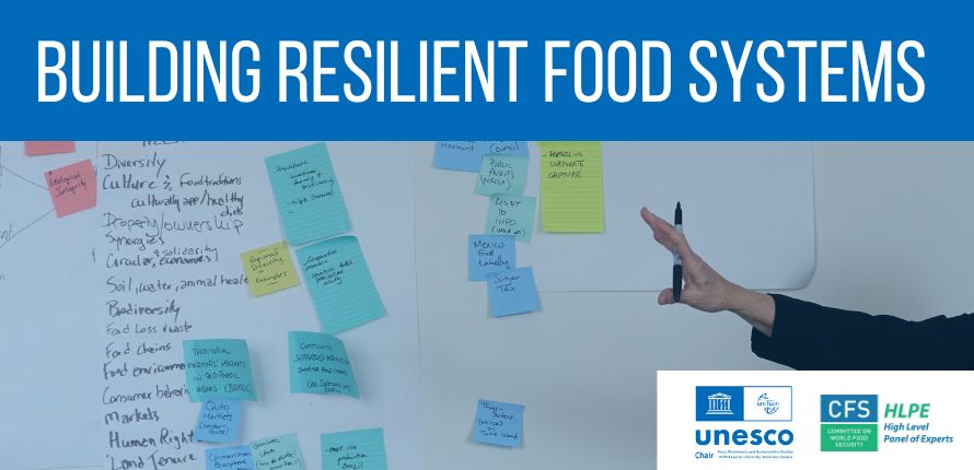 Post-it notes on a wall with a blue header and white text that reads Building Resilient Food Systems