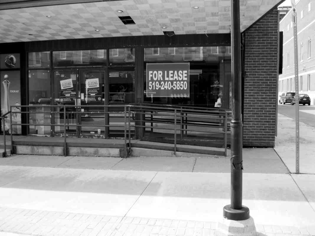 Downtown store front with for lease sign in window